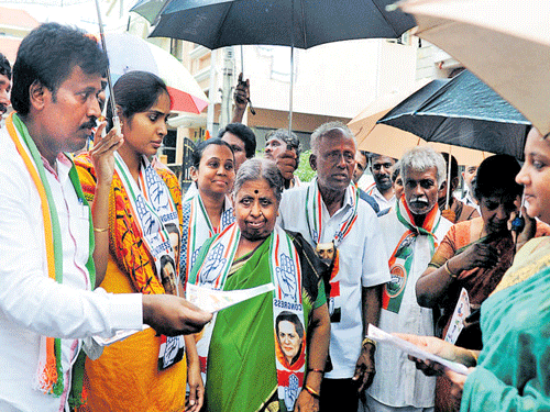 on the trail: Congress candidate from Kathriguppe (ward number 163), N Chuchendrakumar, canvasses for votes at  Srinivasanagar on Wednesday, along with mother Sarojamma, father Narayanappa and wife Chaitra.  dh Photos