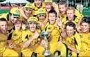 Champions: The victorious Australian team poses with the under-19 World Cup in  Lincoln, New Zealand on Saturday. AFP
