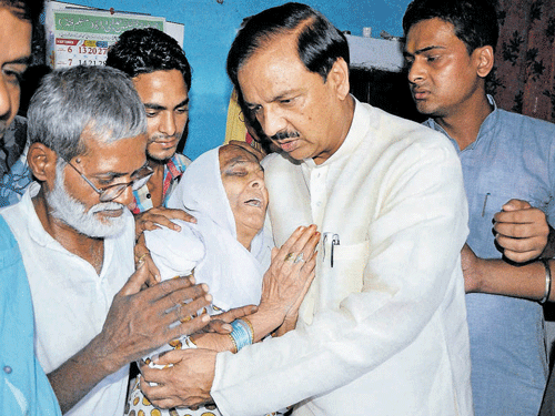 too little too late: Minister Mahesh Sharma consoles Akhlaq's family on Friday. PTI
