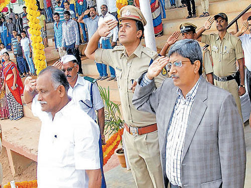 District In-charge Minister K Abhayachandra Jain salutes the National flag during the 60th Kannada Rajyotsava celebrations in Chikkamagaluru on Sunday. DH photo