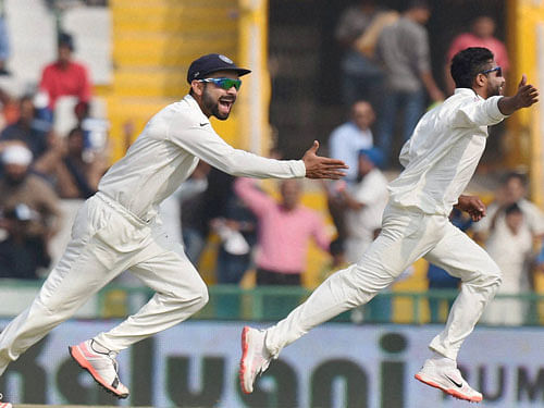 India's Ravindra Jadeja with skipper Virat Kohli celebrates the wicket of South Africa's Hashim Amla during the 3rd day of first Test match in Mohali on Saturday. PTI Photo