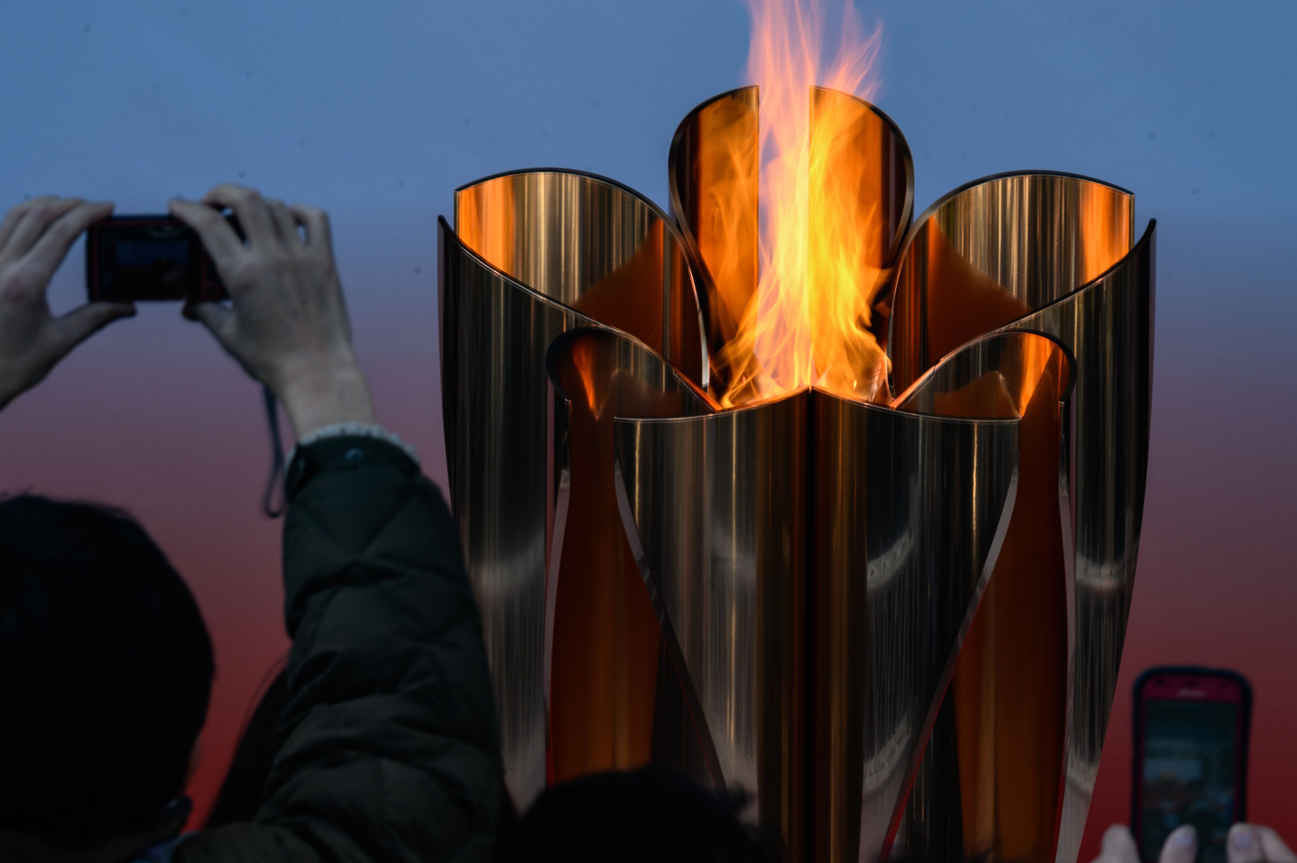 The Tokyo 2020 Olympic flame is displayed outside Sendai railway station, Miyagi prefecture on March 21, 2020, after arriving from Greece. (Credit: AFP)