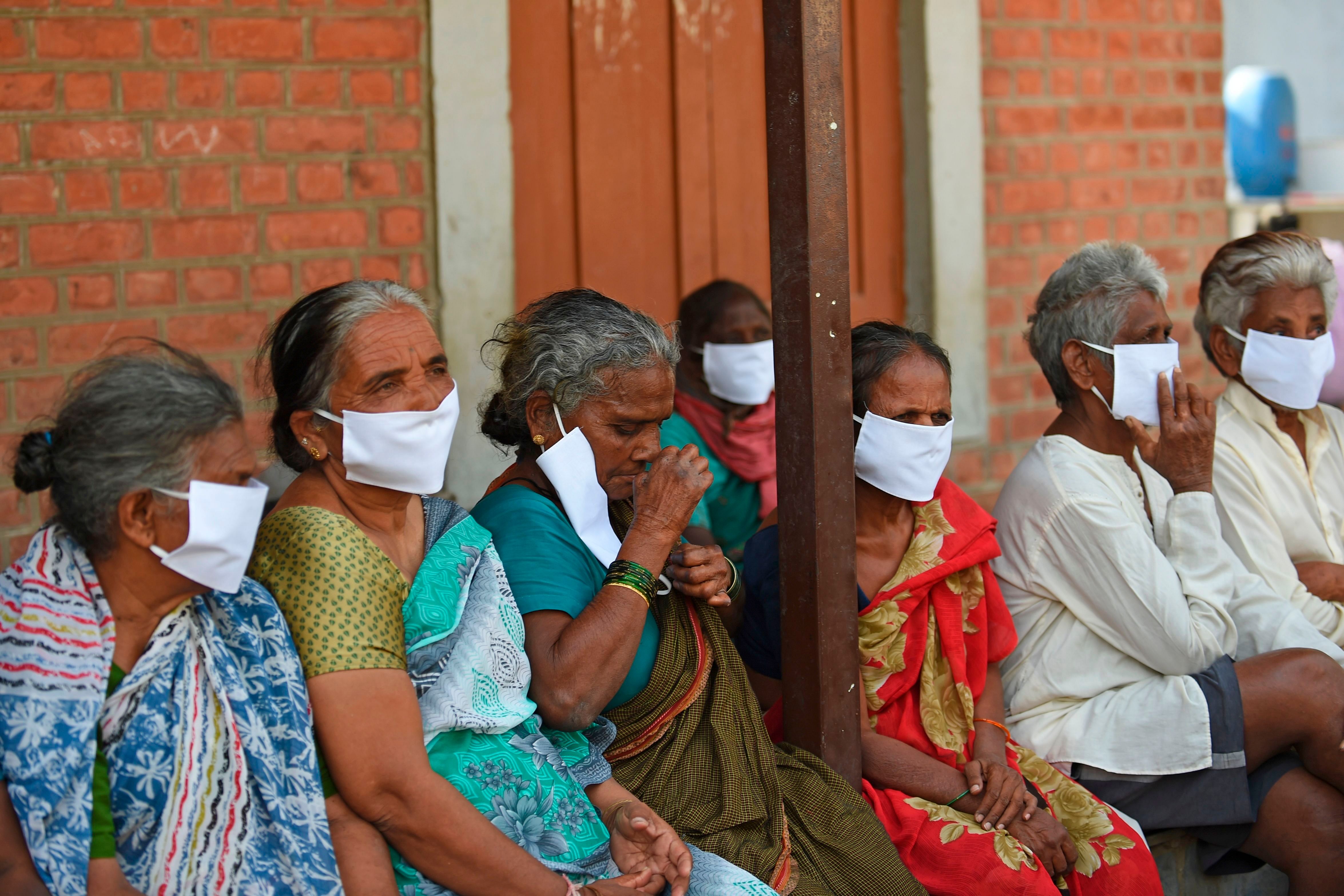 Leprosy affected people, wear facemasks being distributed by a non-governmental organisation amid concerns over the spread of the COVID-19 novel coronavirus. (AFP Photo)