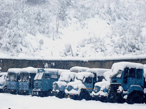A view of Central Reserve Police Force vehicles covered with snow during heavy snowfall near Jawahar Tunnel in the Pir Panjal mountain range at Qazigund in Anantnag. PTI photo