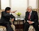 Minister of State for External Affairs Shashi Tharoor (L) gestures while talking with Palestinian President Mahmoud Abbas (R) during a meeting in New Delhi on Friday. AFP