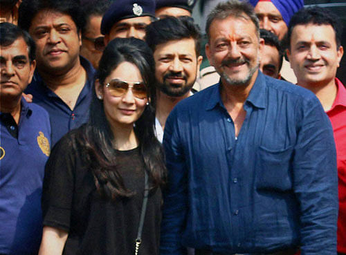 Actor Sanjay Dutt with wife Manyata Dutt arrives at the domestic airport in Mumbai after his release from Pune's Yerawada Jail on Thursday. PTI Photo