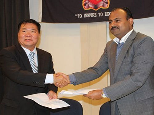 Governor Sasindran Muthuvel shakes hand with David Chung, a FIFA official, in this file photo. Pic courtesy PNG Football.
