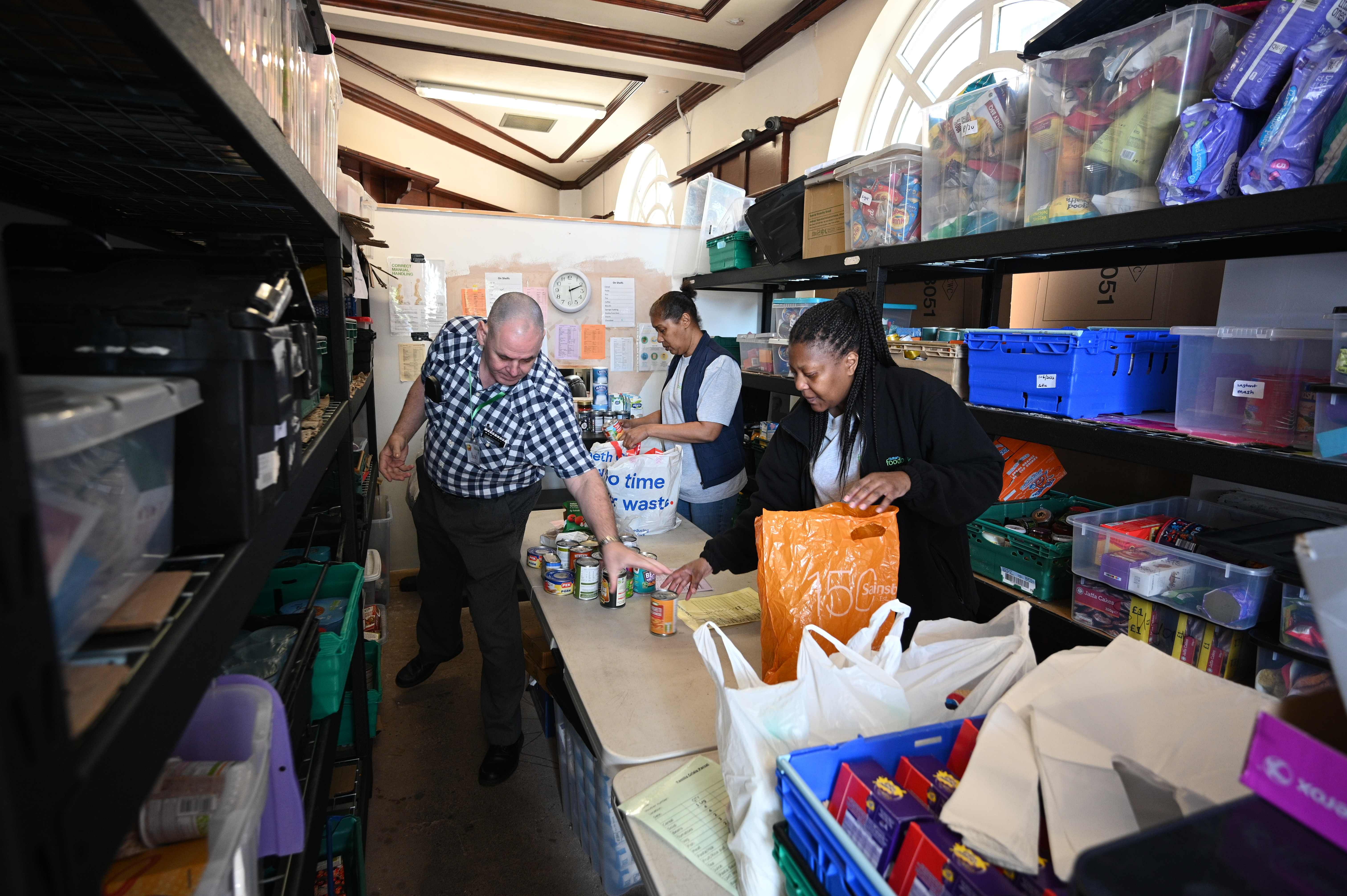 Volunteers pack food inside a Trussell Trust food bank in Oldham, northwest England. (Credit: AFP Photo)