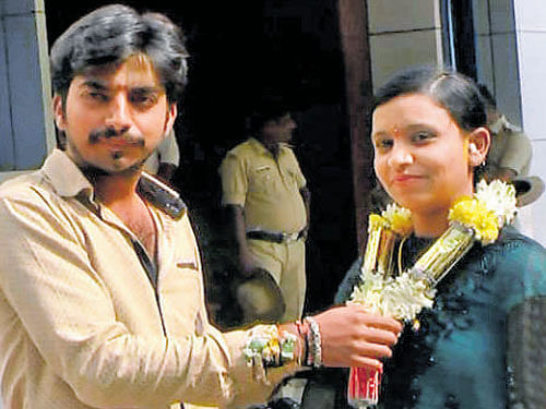 Pradeep garlands Neha  Anjum at the office of the  Superintendent of Police in Hassan on Wednesday.