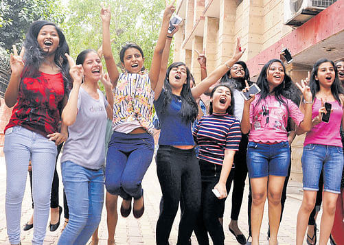 Students celebrate their success in New Delhi on Saturday. Photo Chaman Gautam