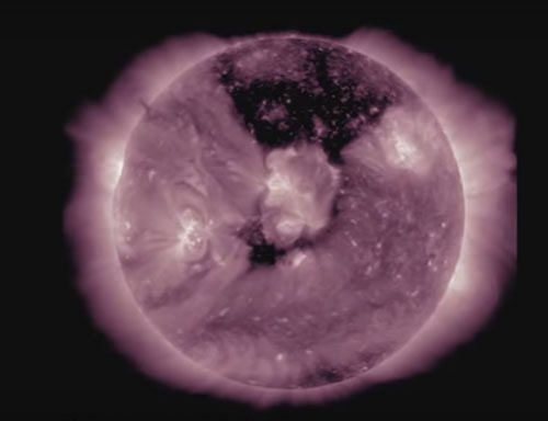 This imagery of the sun captured by NASA's Solar Dynamics Observatory from May 17-19, 2016, shows a giant dark area on the star's upper half, known as a coronal hole. NASA/SDO