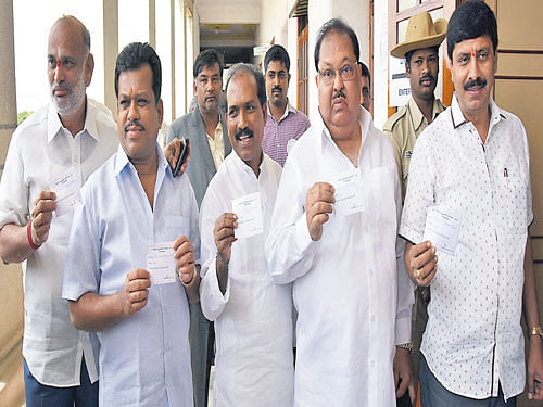 (From left): MLAs Shivaram Hebbar, Parameshwar Naik, Abbayya Prasad, Qamar-ul-Islam and Y A Narayanaswamy line up for casting their votes in the Rajya Sabha elections at the  Vidhana Soudha in Bengaluru on Saturday. Dh Photo