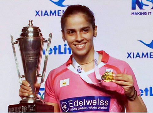 India's ace shuttler Saina Nehwal with the trophy after winning her second Australian Open Superseries title by defeating China's Sun Yu in the Australian Open finals in Sydney on Sunday. PTI Photo