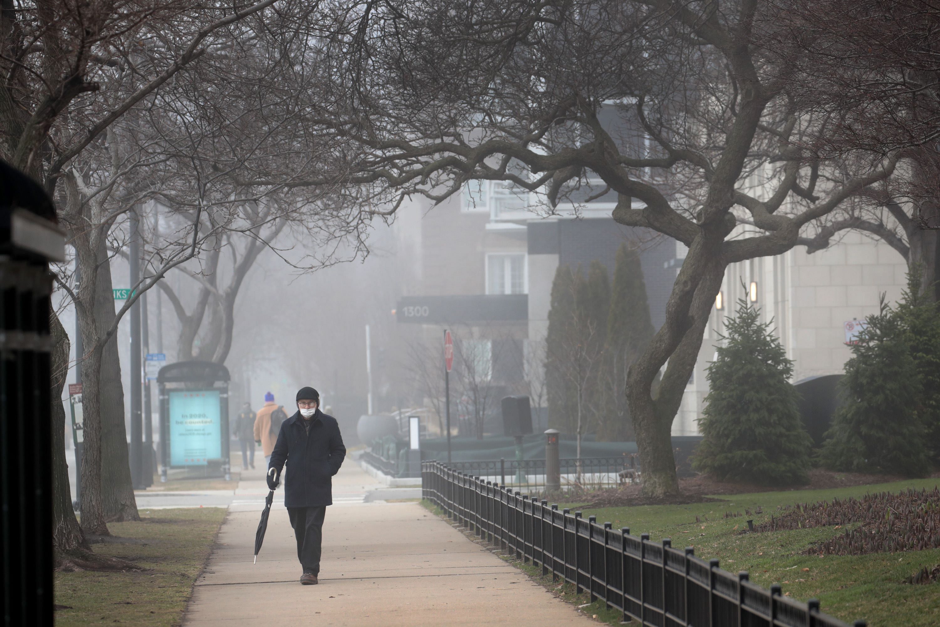 Pedestrians stroll along Lake Shore Drive across the Lake Michigan. (Credit: AFP)