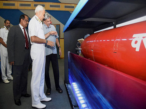 Defence Minister Manohar Parrikar with Navy chief Admiral Sunil Lanba takes a look of a model of the heavy weight anti submarine torpedo Varunastra after it was handed over to the Indian Navy in New Delhi on Wednesday. PTI Photo