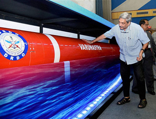 Defence Minister Manohar Parrikar takes a look at a model of the heavyweight anti-submarine torpedo 'Varunastra' after it was handed over to the Navy in New Delhi on Wednesday. PTI