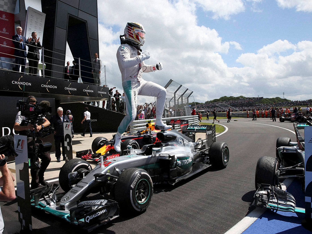 Mercedes driver Lewis Hamilton jumps from his car in celebration after winning the British Formula One Grand Prix at the Silverstone racetrack, Silverstone, England. AP/PTI photo