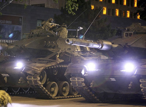 A military aims his weapon on top of a tank during an attempted coup in Ankara. Reuters
