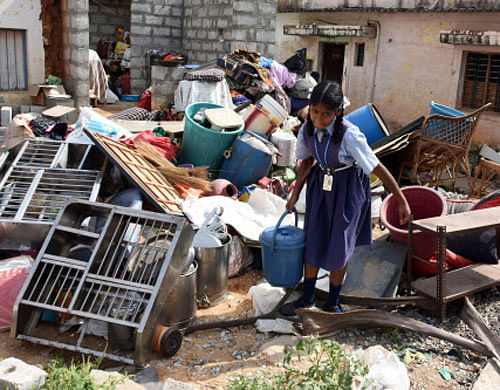 A school girl retrieving her family's belongings. DH Photo