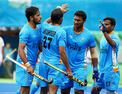 Akashdeep Singh of India (C) celebrates with his teammates after scoring a goal. REUTERS