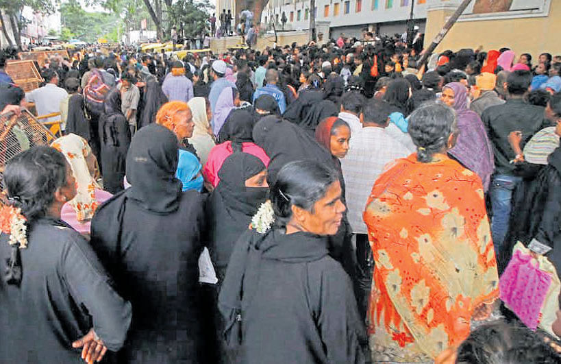 A crowd gathers at the AKP convention hall in Shivajinagar where tokens for free rations were distributed to poor  people. dh photo