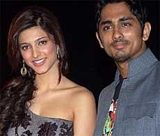 Bollywood personalities Shruti Hassan (L) and Siddharth pose for photographs during a Walt Disney India event at a movie theatre in Mumbai on March 11, 2010. AFP