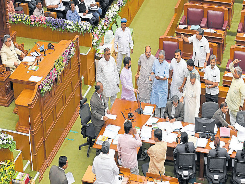 BJP members stage a dharna in the Legislative Assembly to protest farmers' arrest in Belagavi on Monday. DH PHOTO