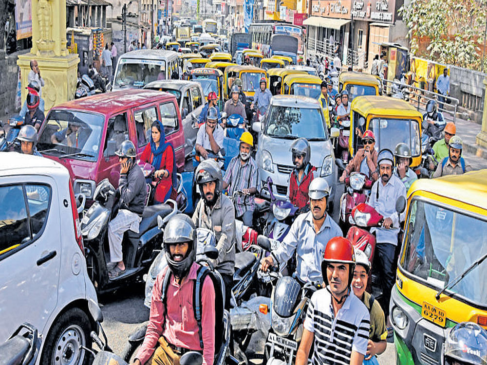 Traffic was usual near Corporation on Monday despite the protest called by the Congress and other parties. DH Photo