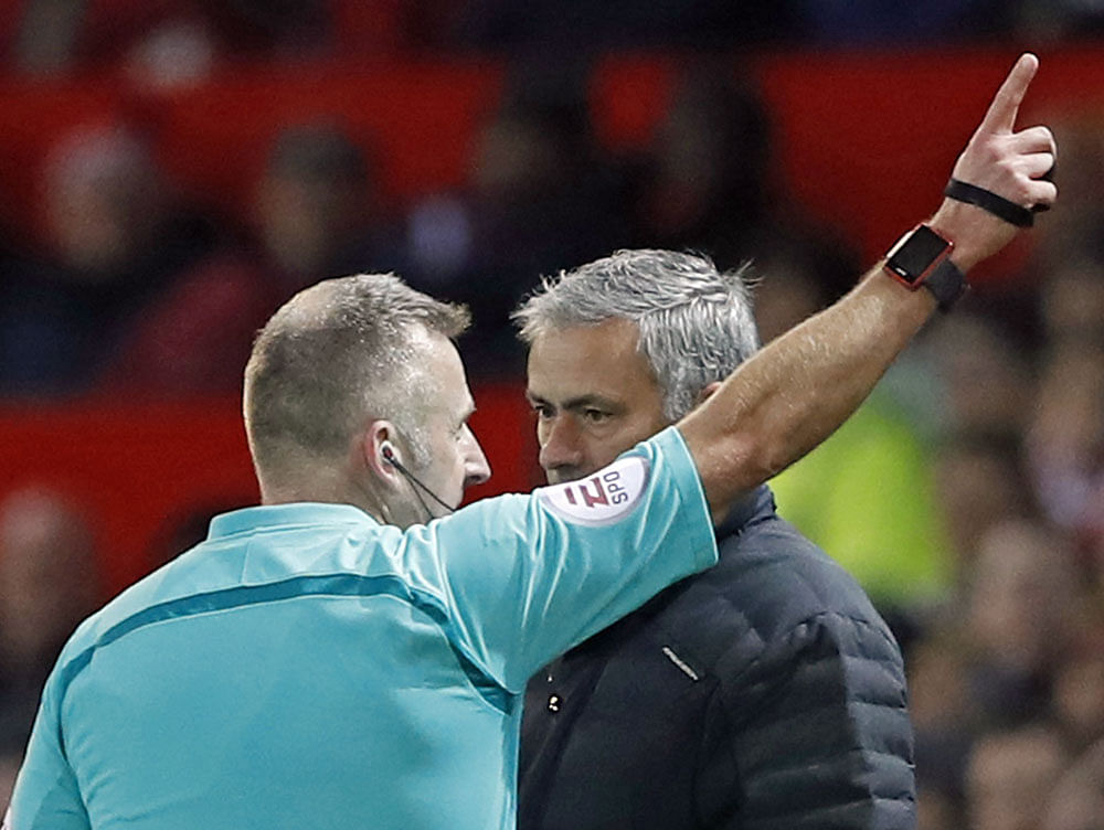 Off you go: Referee Jonathon Moss sends Manchester United manager Jose Mourinho to the stands. Reuters