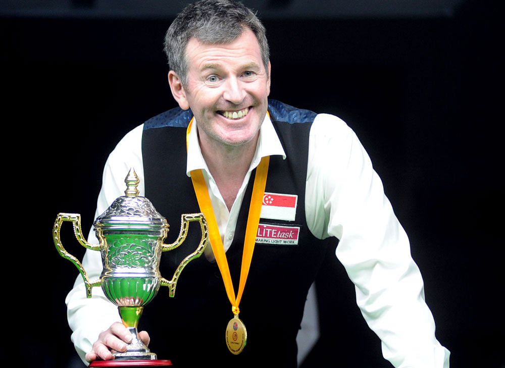 All Smiles: Singapore's Peter Gilchrist with his spoils after clinching the World Billiards Championship in Bengaluru on Thursday. DH Photo/ Srikanta Sharma R