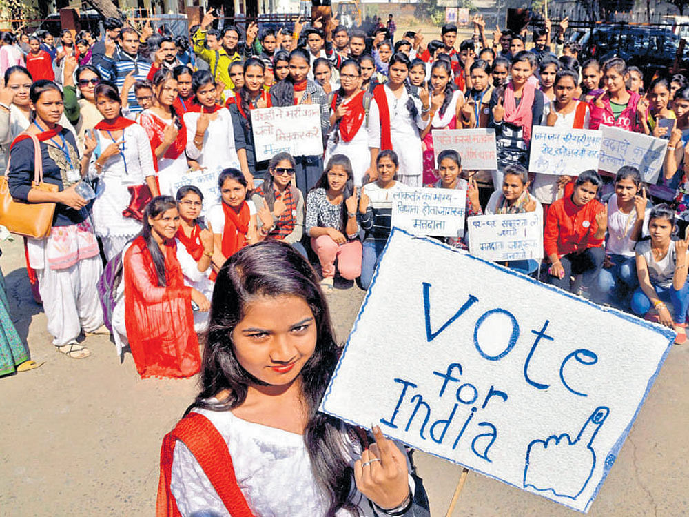 Girls take part in a voting awareness campaign in Jabalpur on National Voters' Day on Wednesday. PTI