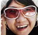 A  reflection of Google logo is seen in a womans glasses in front of its China headquarters in Beijing on Tuesday. REUTERS