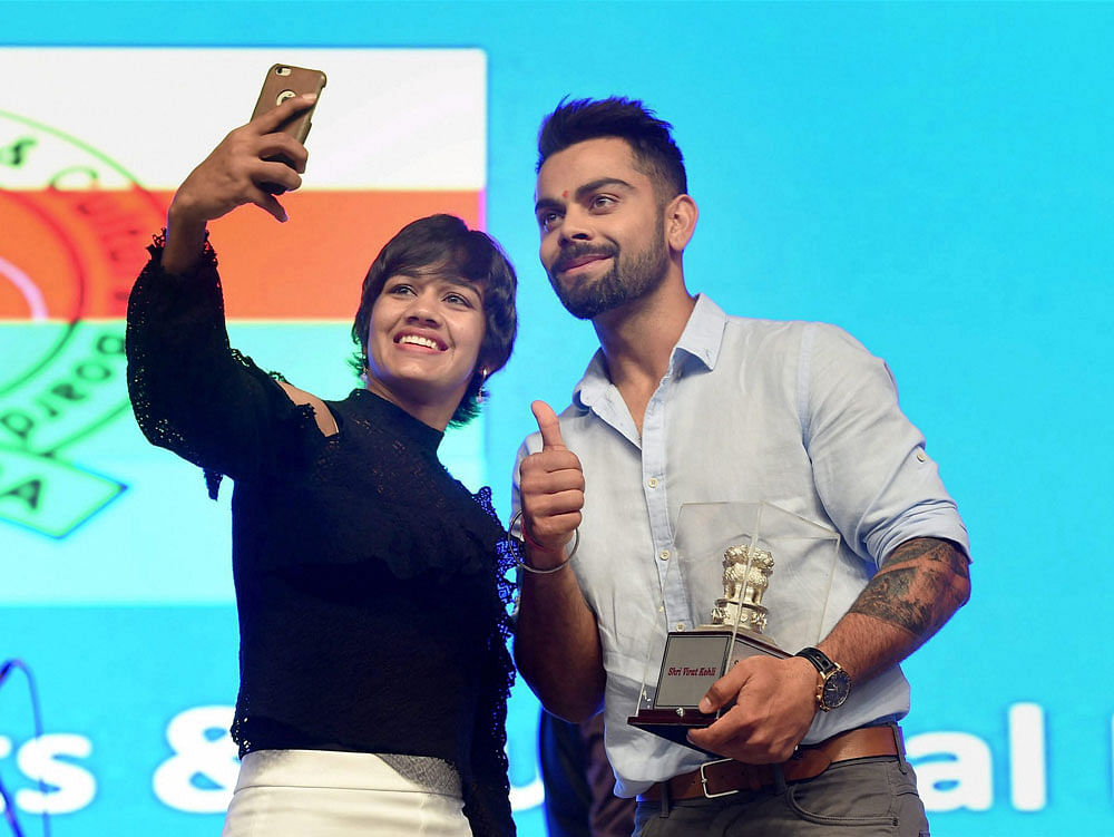 Team India captain, Virat Kohli and Wrestler, Babita Phogat during the concluding ceremony of the 49th All India Central Revenue Sports Meet in Mumbai on Friday. PTI Photo