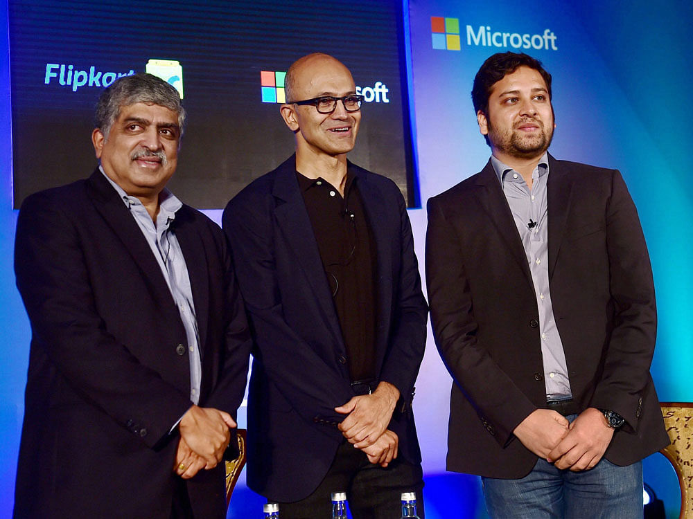 Microsoft CEO Satya Nadella in discussion with EkStep Co Founder and Chairman Nandan Nilekani and Flipkart co-founder and CEO Binny Bansal (R) during an event on startup stalwarts of India about digital information,intelligent cloud,AI, in Bengaluru on Monday. PTI Photo