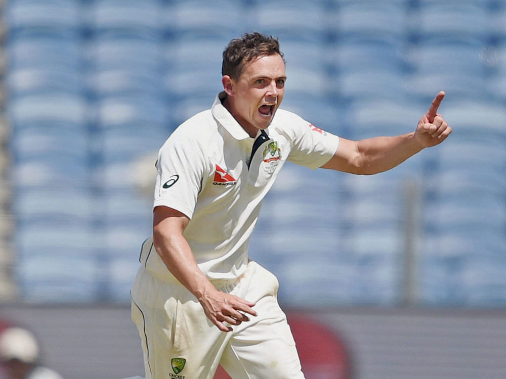 Australian bowler Steve O'Keefe celebrates the wicket of Indian batsman Wriddhiman Saha during the 2nd day of the first test match against India in Pune on Friday. PTI Photo