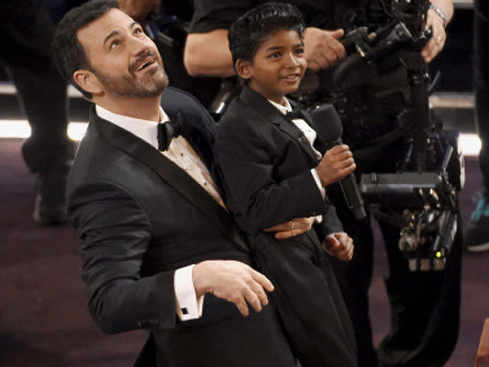 Host Jimmy Kimmel, left, holds 'Lion' actor Sunny Pawar at the Oscars on Sunday, Feb. 26, 2017, at the Dolby Theatre in Los Angeles. AP/PTI