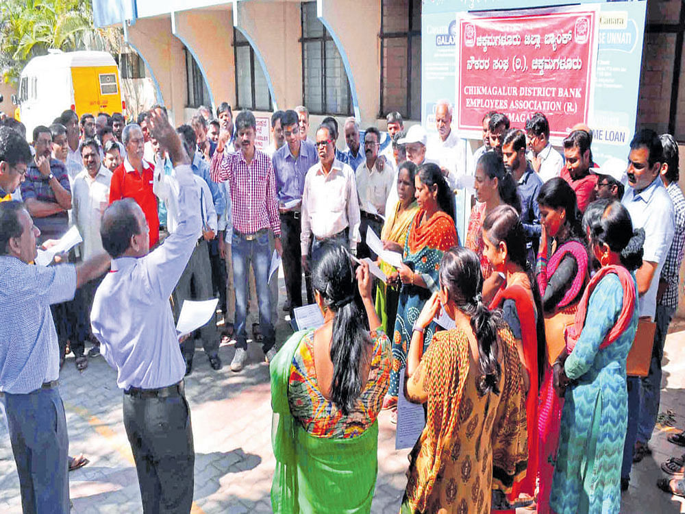Canara Bank staff protest in front of Canara Bank (main) branch in Chikkamagaluru on Tuesday.