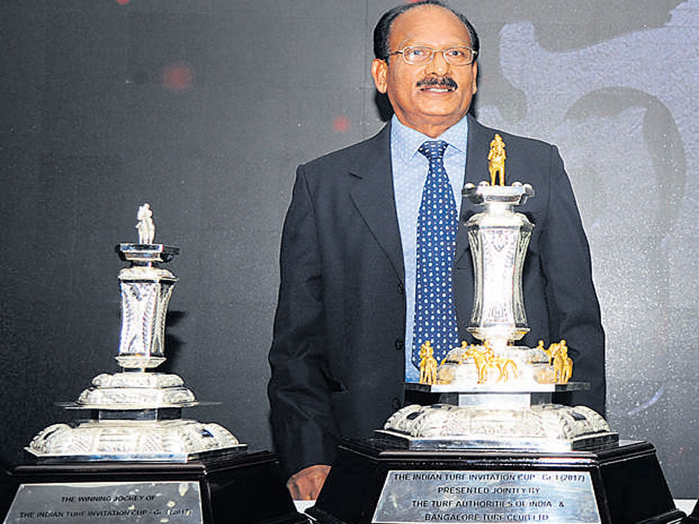 glittering Bangalore Turf Club chairman Harindra Shetty with the Invitation Cup Trophy at the draw ceremony in Bengaluru on Wednesday. DH PHOTO