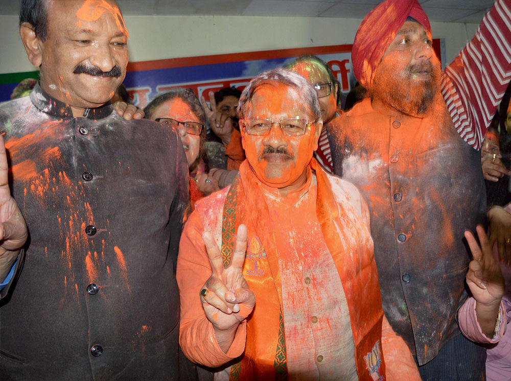 BJP in-charge for Uttarakhand, Shyam Jaju celebrating the party's victory in Assembly elections in Dehradun on Saturday. PTI Photo