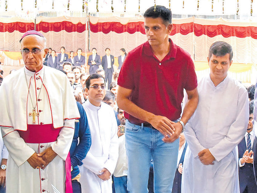 Former India cricket captain Rahul Dravid arrives for the inauguration of the new campus of St Joseph's Institute of Management in Bengaluru on Sunday. Archbishop of Bengaluru Dr Bernard Moras is seen. DH PHOTO