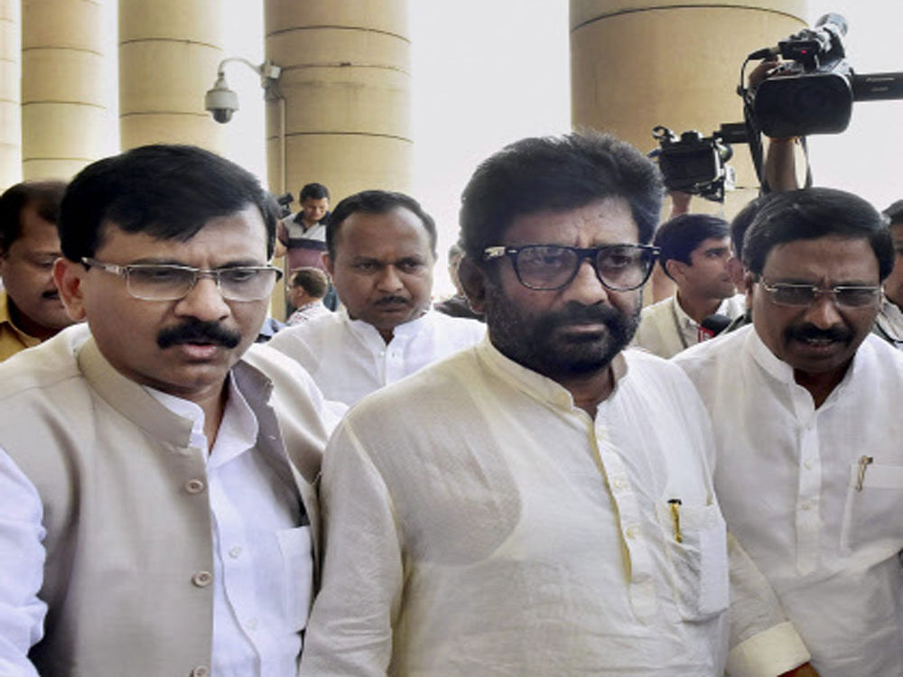 Ravindra Gaikwad (C) with Shiv Sena spokesperson Sanjay Raut (L) and party MPs after a press conference at Parliament in New Delhi on Thursday after he apologized in the Lok Sabha for his recent assault on an Air India employee. PTI Photo