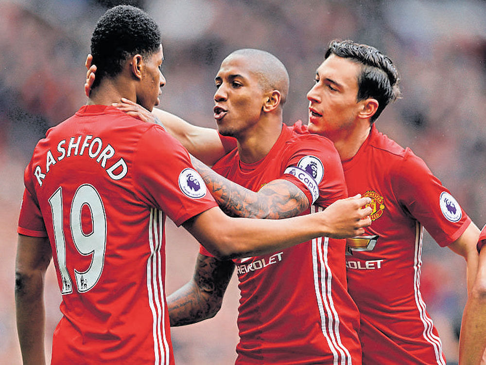 first strike Manchester United's Marcus Rashford (left) celebrates with team-mates after scoring against Chelsea. AFP
