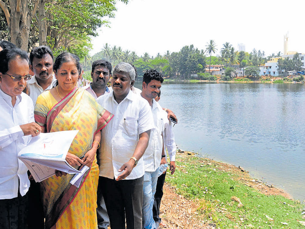 Union Minister of Commerce and Industries Nirmala Sitharaman visits Kalena Agrahara lake to launch development works on Saturday. Bengaluru South MLA M Krishnappa, BBMP Commissioner Manjunath Prasad and others are seen. dh Photo