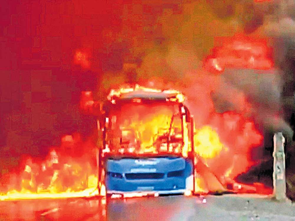 slipping out of hand: A bus was torched by farmers on the Bhopal-Indore highway in Dewas district of Madhya Pradesh on  Wednesday. pti