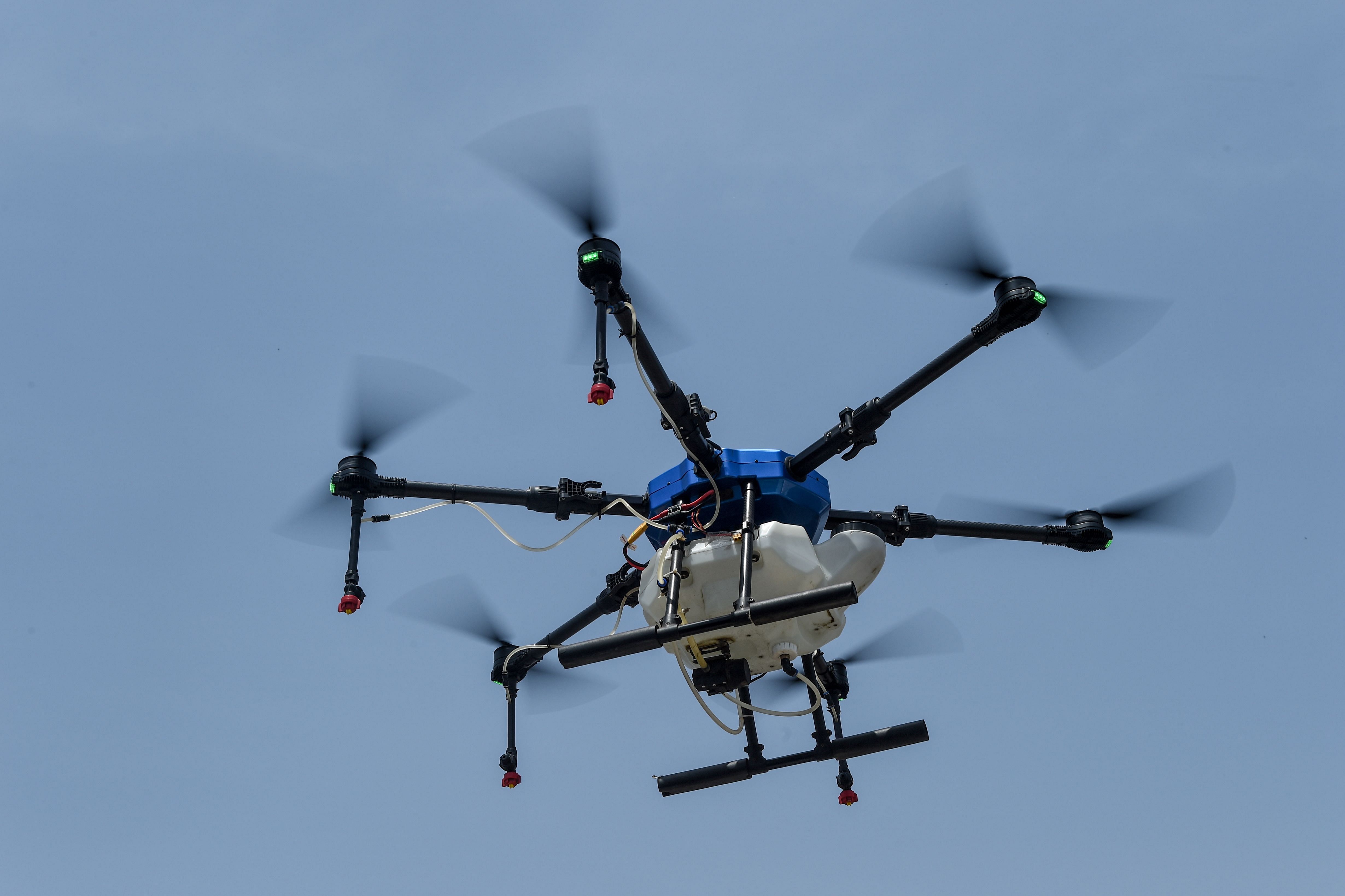 A drone is used to spray disinfectant over residential areas during a government-imposed nationwide lockdown as a preventive measure against the COVID-19 coronavirus, in Ahmedabad. (Credit: AFP Photo)