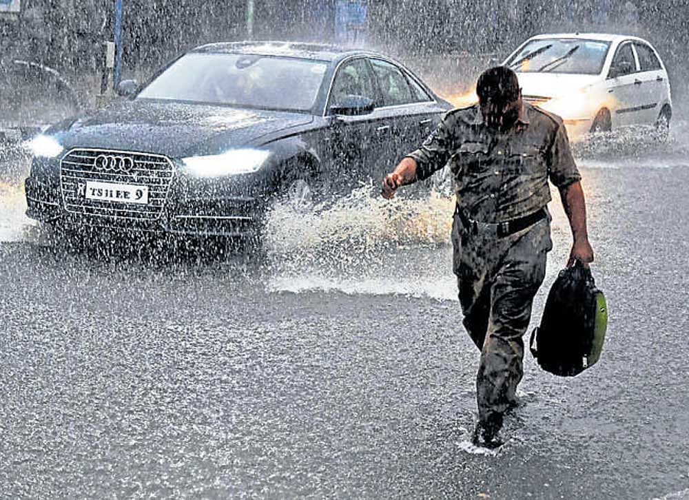 Streets flooded with water after heavy rain lashed Hyderabad on Friday evening. PTI