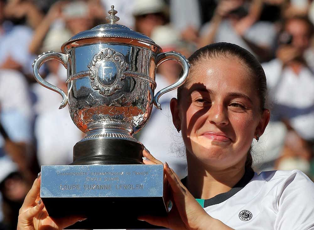 Latvia's Jelena Ostapenko holds the cup after defeating Romania's Simona Halep in their final match of the French Open tennis tournament at the Roland Garros stadium. AP/PTI