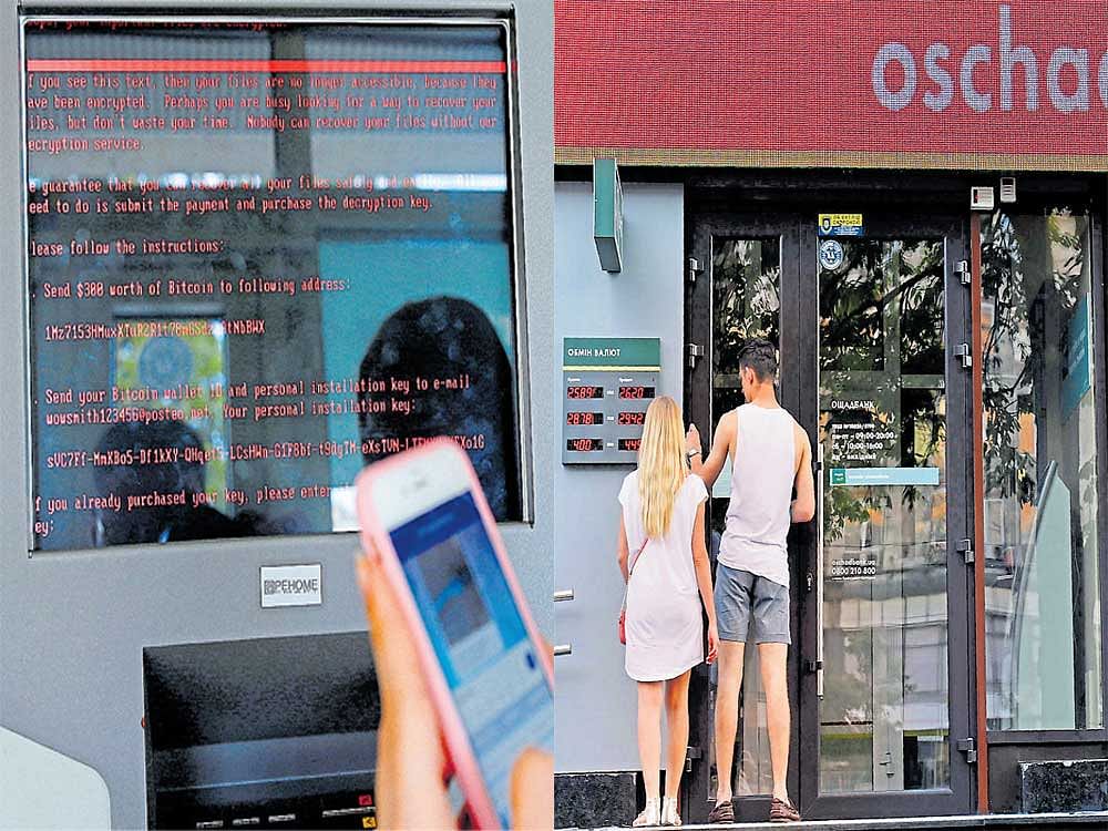 crippled: (L) A message demanding money is seen on a monitor of a payment terminal at Ukraine's state-owned Oschadbank. People outside a closed branch of Oschadbank after Ukrainian institutions were hit by a wave of cyberattacks on Tuesday, in Kiev. AFP/Reuters