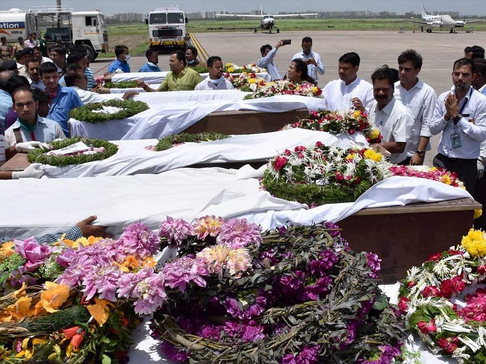People paying tributes to the Amarnath pilgrims who were killed Monday's militant attack at Anantnag in J & K, after their bodies were brought in an IAF plane at the airport in Surat on Tuesday. PTI Photo