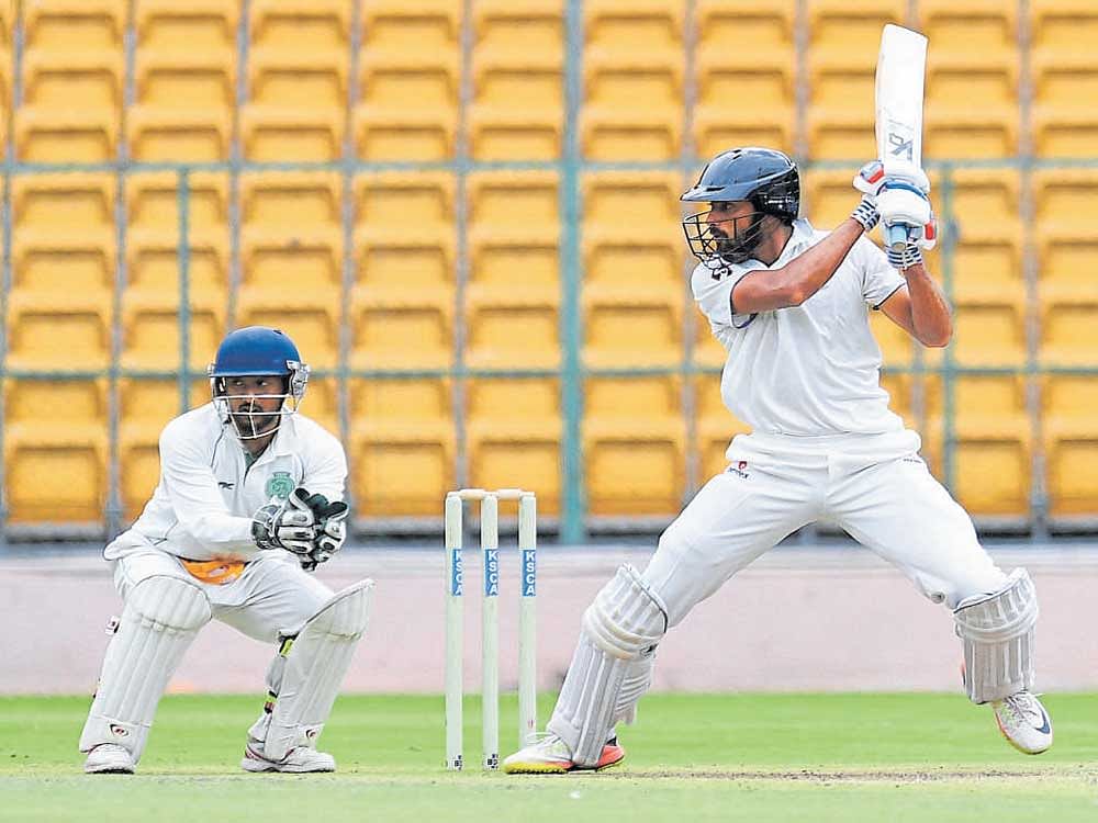 ELEGANT KSCA XI's Mir Kaunain Abbas cuts one to the fence en route to his 137 against Assam on Sunday. DH PHOTO